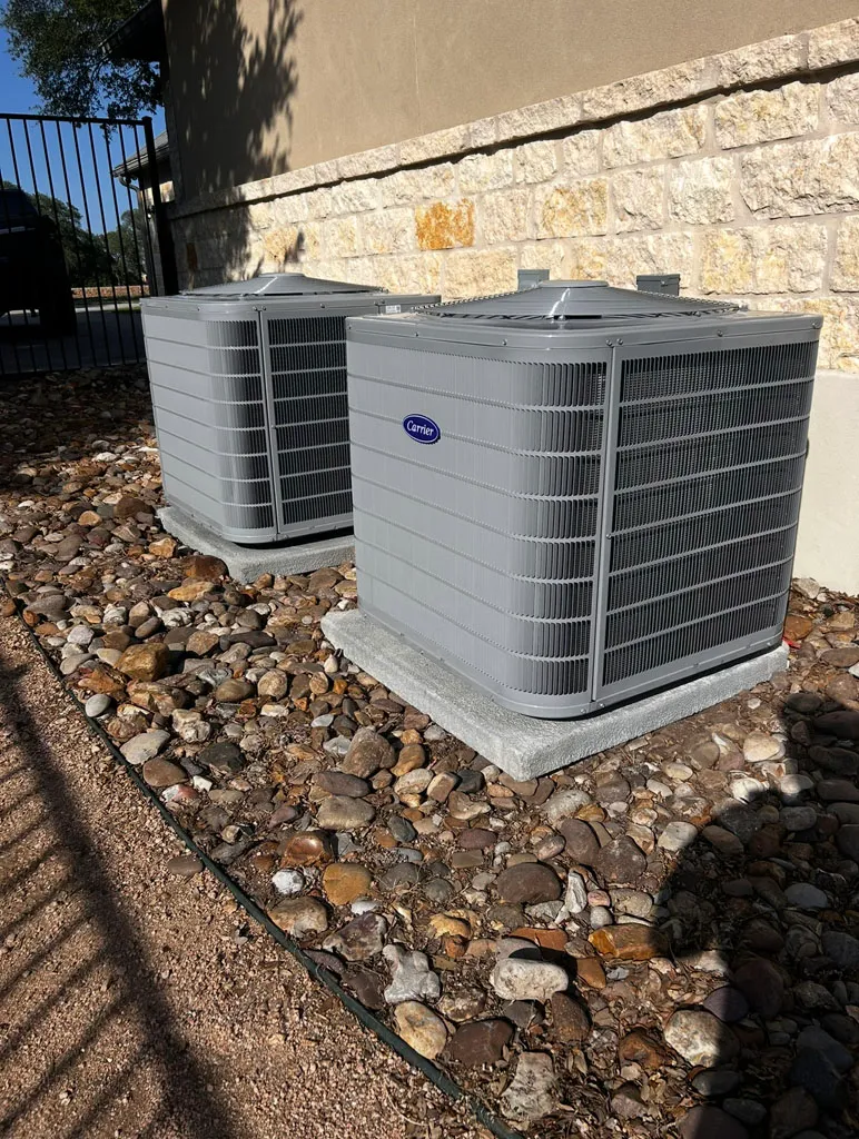 Dual residential condensers on river-rock pad